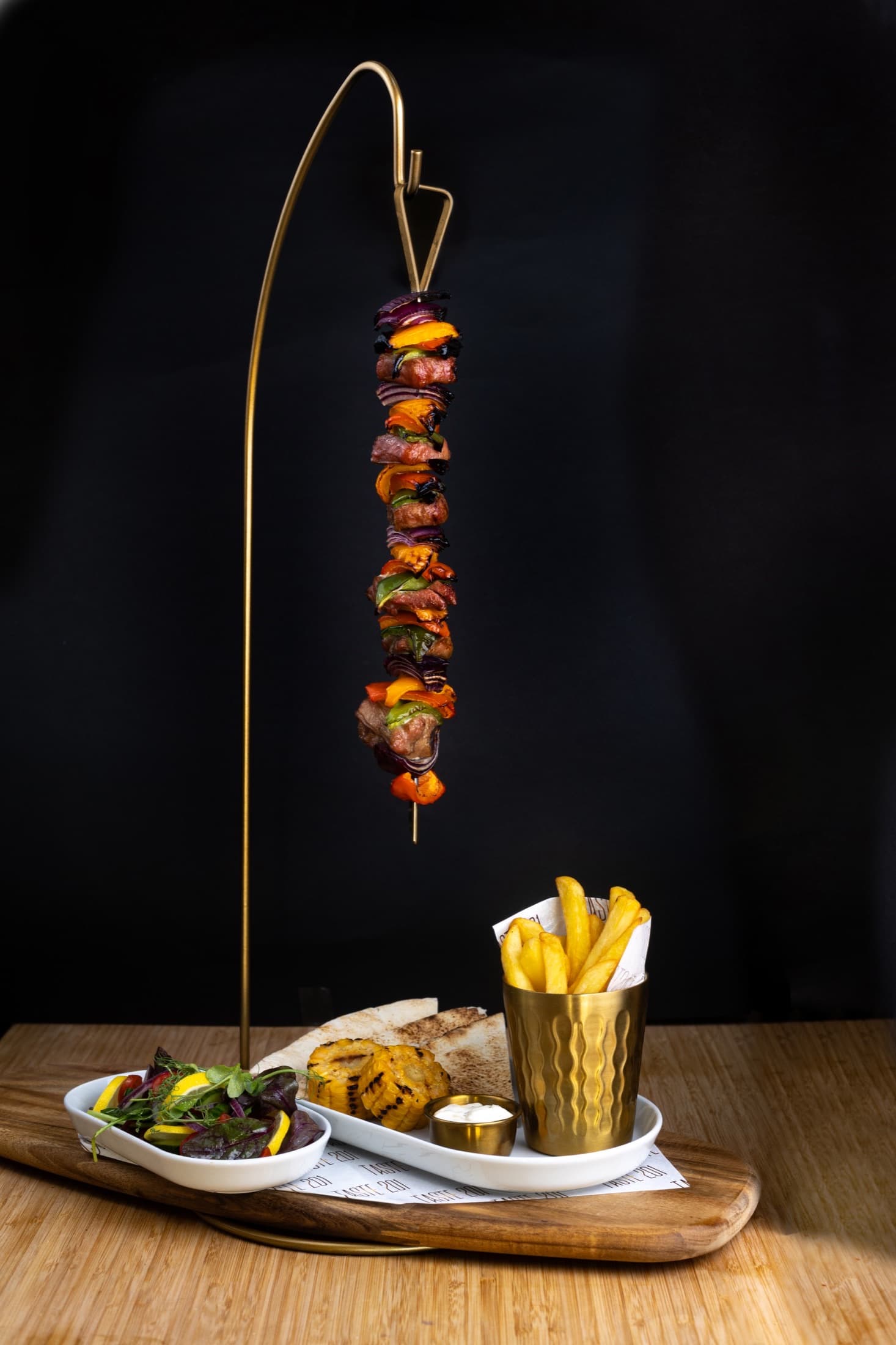 Hanging grill skewers with flatbread and fries